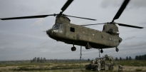 Soldiers attaching a Humvee to a Chinook helicopter