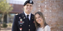 First Lieutenant Officer wearing dress blues standing with family 